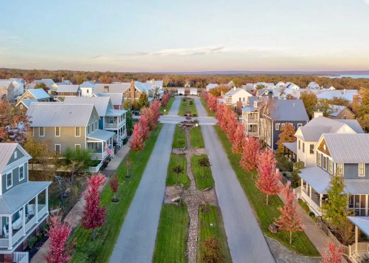 Aerial view of Carlton Landing's tree-lined greenway in fall, Lake Eufaula in the distance